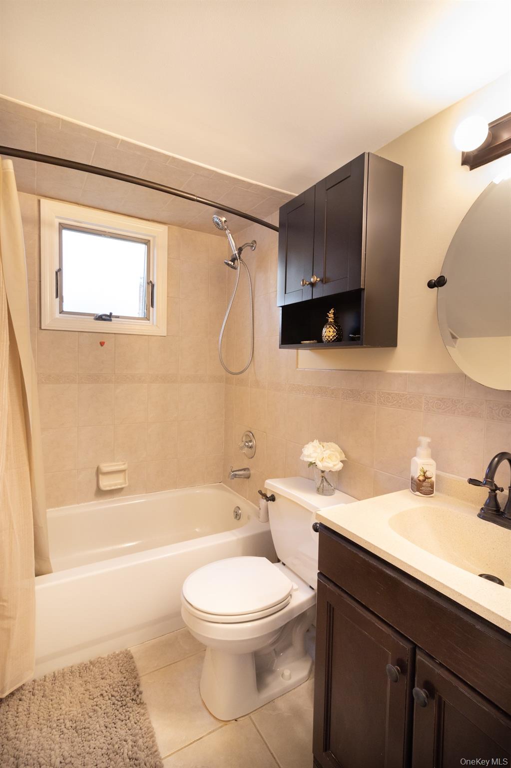 2449 Union Boulevard, Unit 36A Islip, NY 11751 - Photo 9 of 15 a bathroom with a bathtub shower sink vanity mirror and toilet