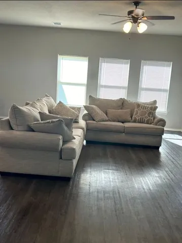 a living room with furniture and a large window