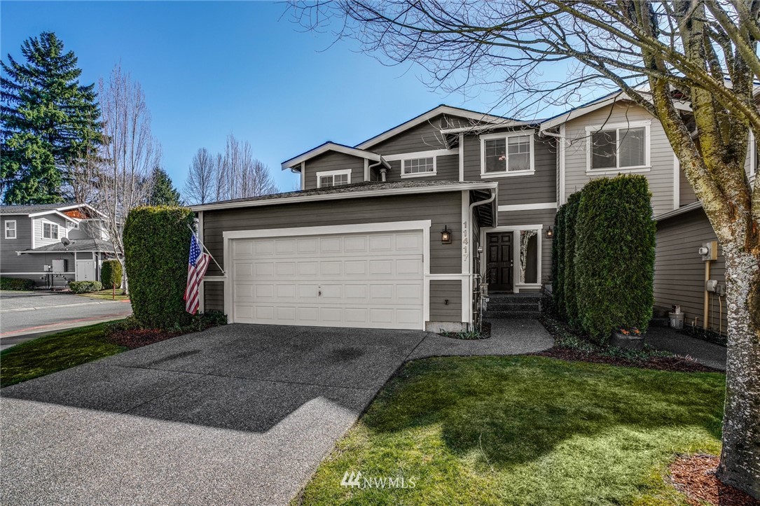 11417 Southeast 171st Street Renton, WA 98055 - Photo 1 of 27 a front view of a house with a yard and garage