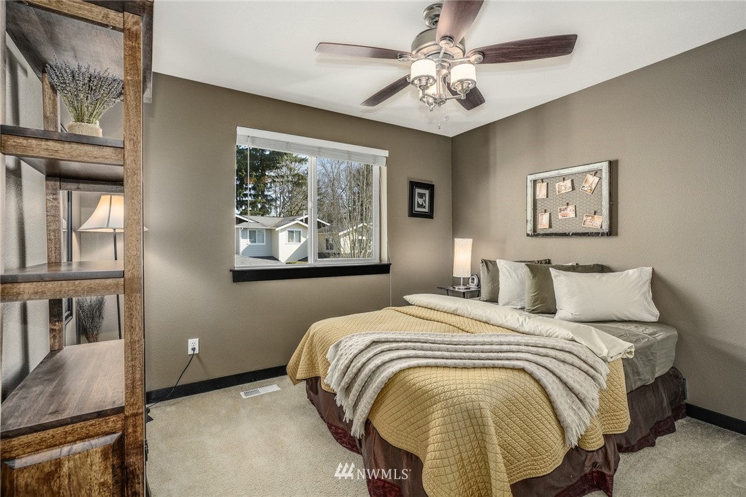 11417 Southeast 171st Street Renton, WA 98055 - Photo 17 of 27 a bed sitting in a bedroom next to a window