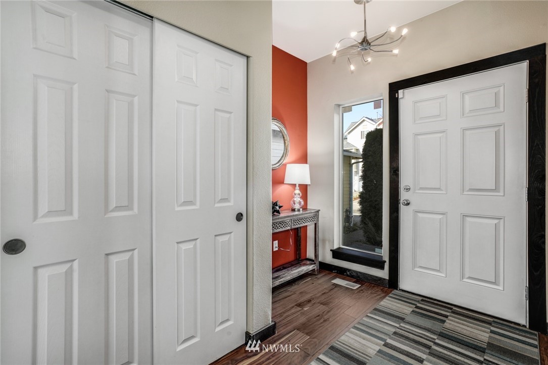 11417 Southeast 171st Street Renton, WA 98055 - Photo 4 of 27 a view of a hallway with wooden floor and staircase
