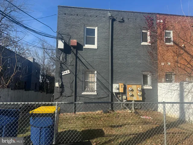 a view of a brick house with large windows