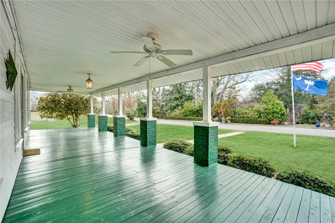 302 Gassaway Street Central, SC 29630 - Photo 27 of 34 Relax on this spacious porch, offering tranquil outdoor living and picturesque garden views.