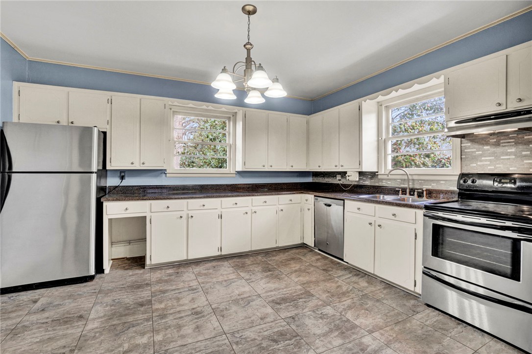 302 Gassaway Street Central, SC 29630 - Photo 7 of 34 This spacious kitchen offers ample cabinetry, modern appliances, and durable flooring for daily living.