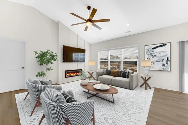 a living room with furniture a fireplace and a flat screen tv