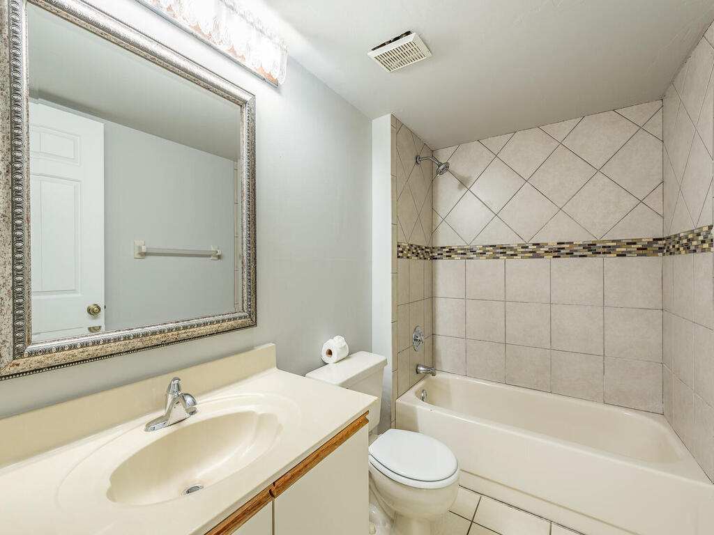 740 Augusta Boulevard, Unit E101 Naples, FL 34113 - Photo 11 of 12 a bathroom with a sink a toilet and shower