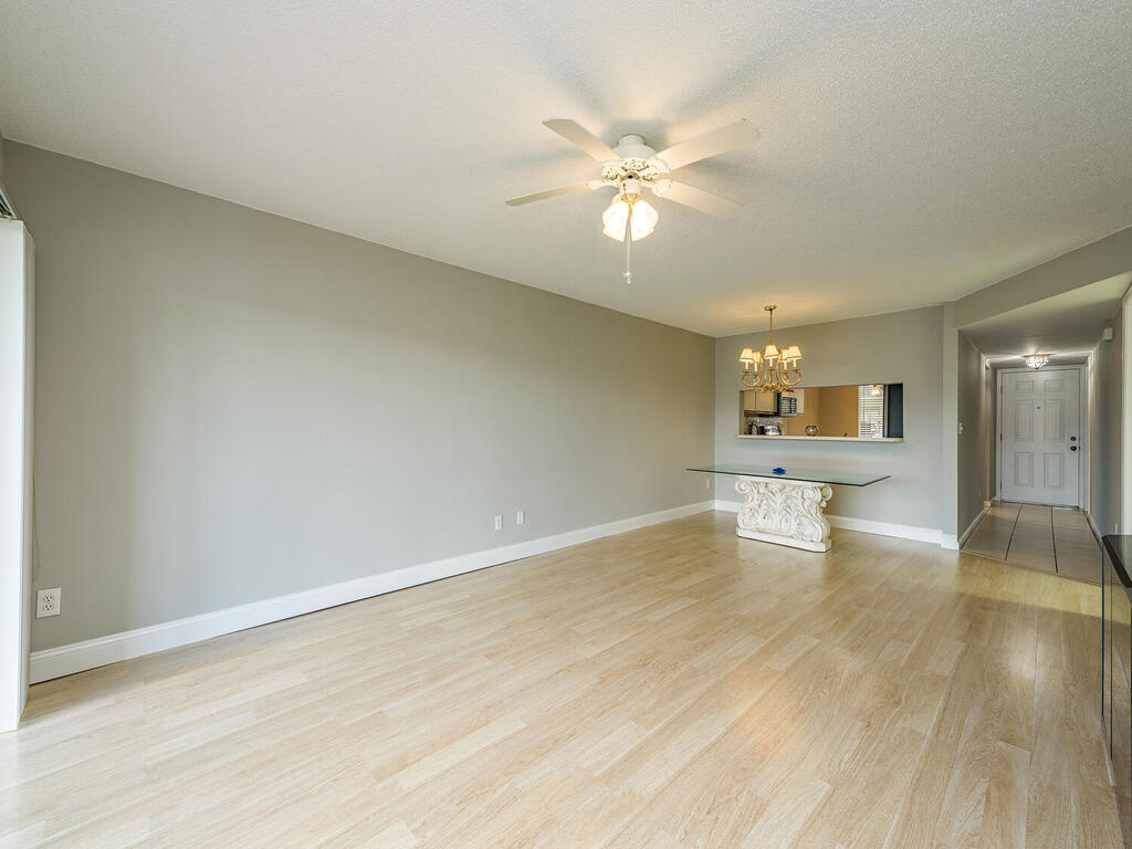 740 Augusta Boulevard, Unit E101 Naples, FL 34113 - Photo 2 of 12 a view of an empty room and wooden floor