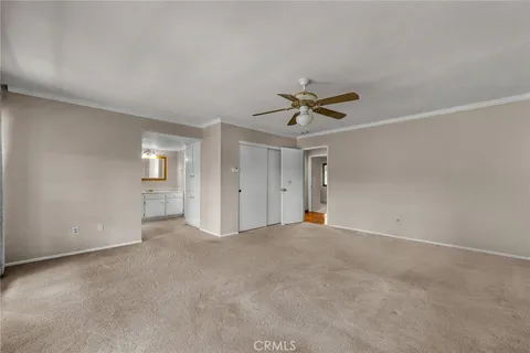 an empty room with a ceiling fan and a window