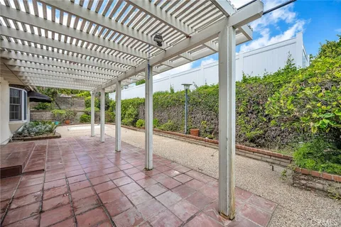 a view of a porch with plants and wooden fence