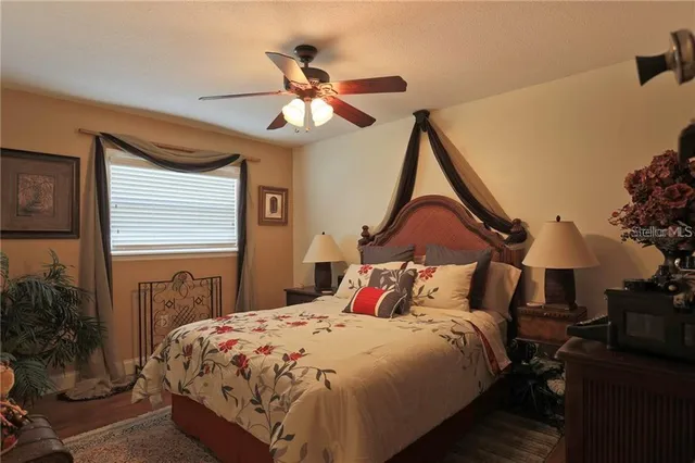 a bedroom with a bed and a chandelier
