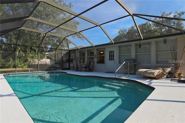 a view of a backyard with sitting area and tub
