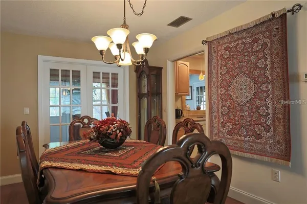a dining room with furniture and chandelier