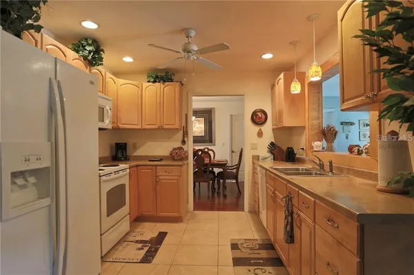 a large kitchen with stainless steel appliances lots of counter space and windows