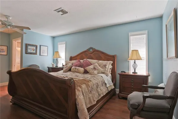 a bedroom with a bed chair and window