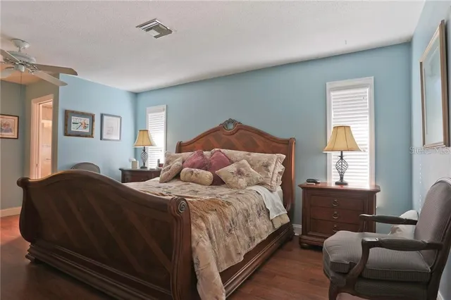 a bedroom with a bed chair and window