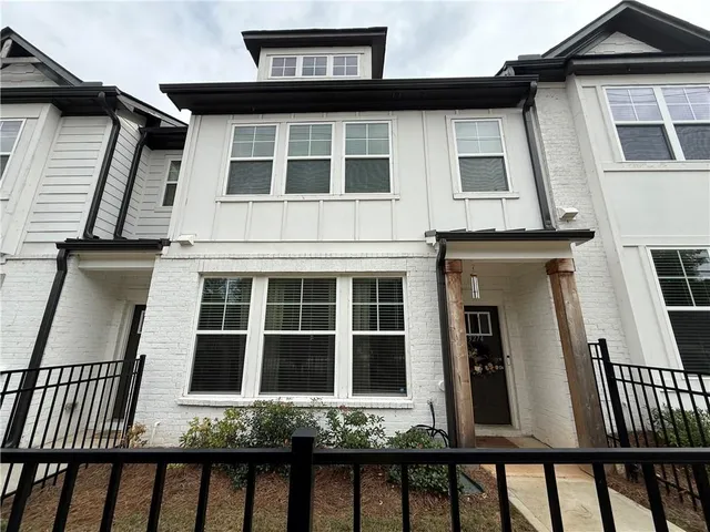 a view of a brick house with large windows