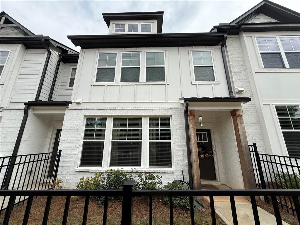 a view of a brick house with large windows