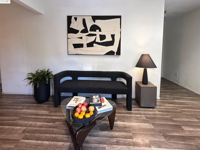 a living room with furniture and a potted plant