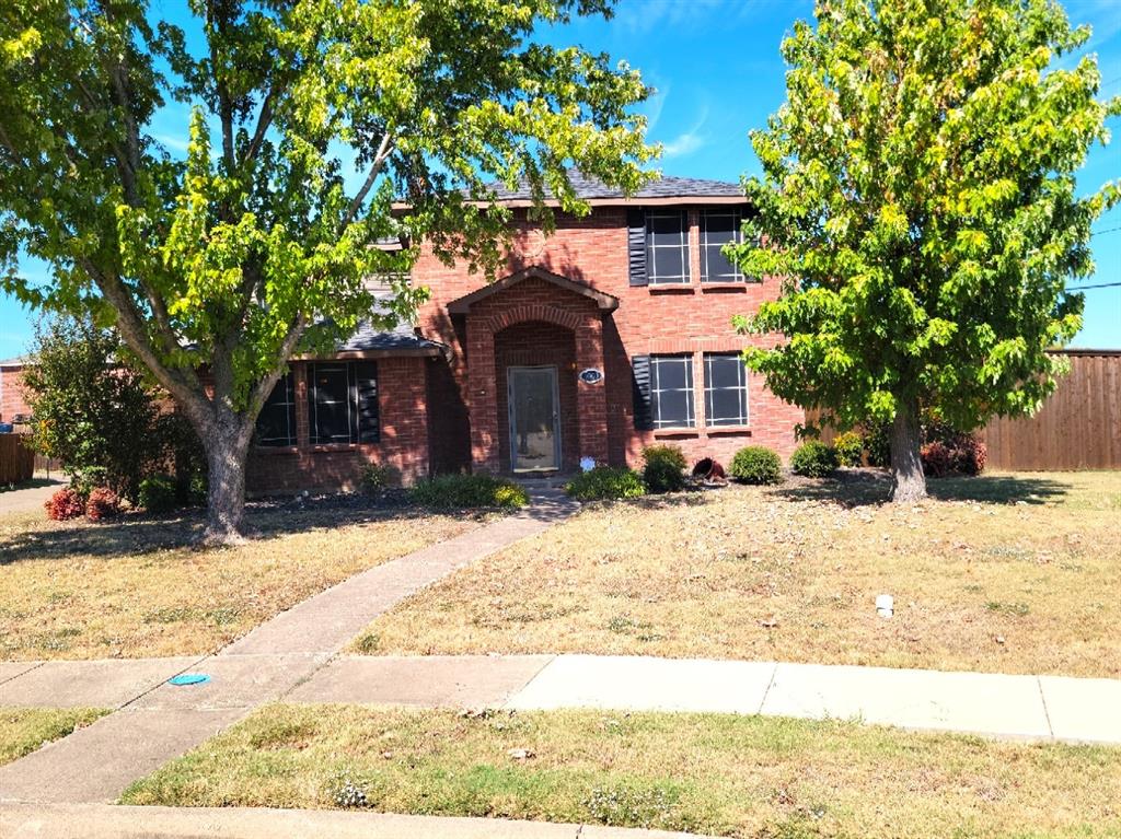 1003 Graystone Drive Lancaster, TX 75134 - Photo 3 of 40 a front view of a house with a yard