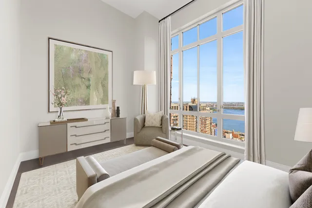 a living room with furniture and large windows