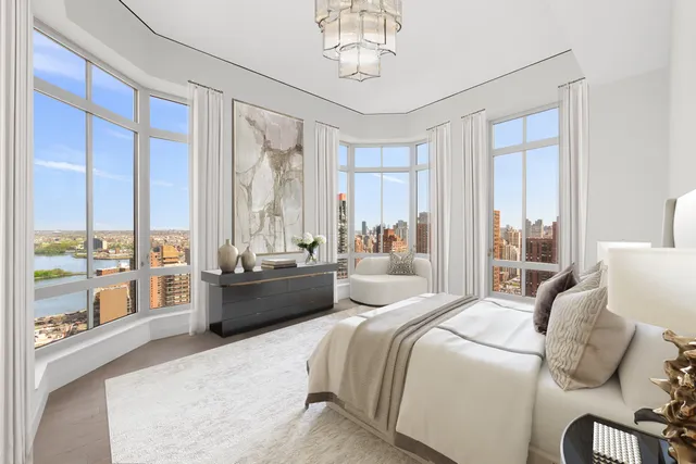 a bedroom with a large bed and a large window