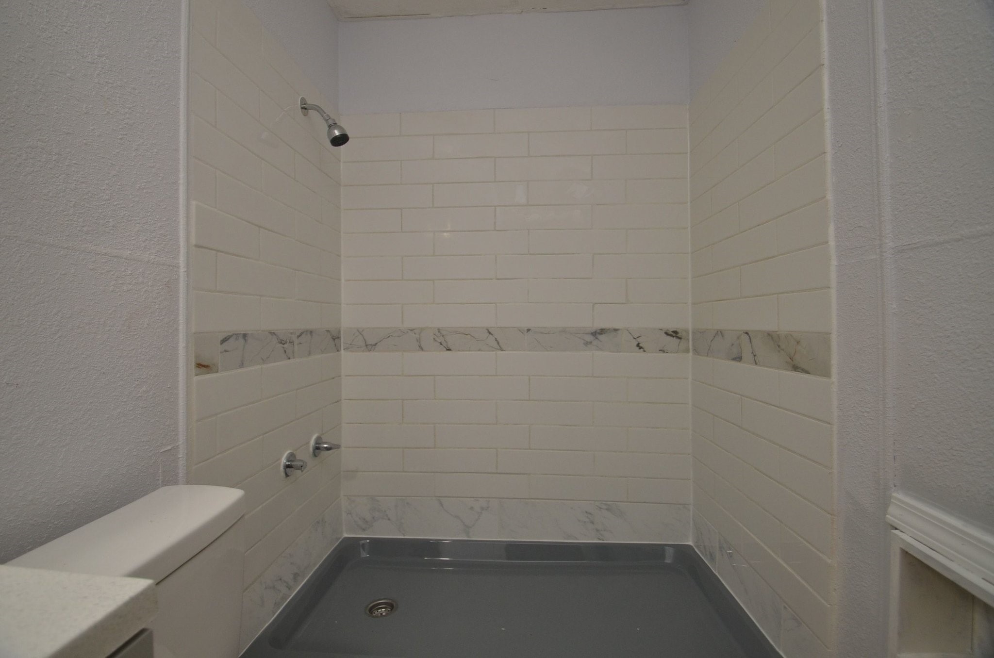 1600 5th Street Rosenberg, TX 77471 - Photo 21 of 24 Clean and functional bathroom with tub and shower combination.