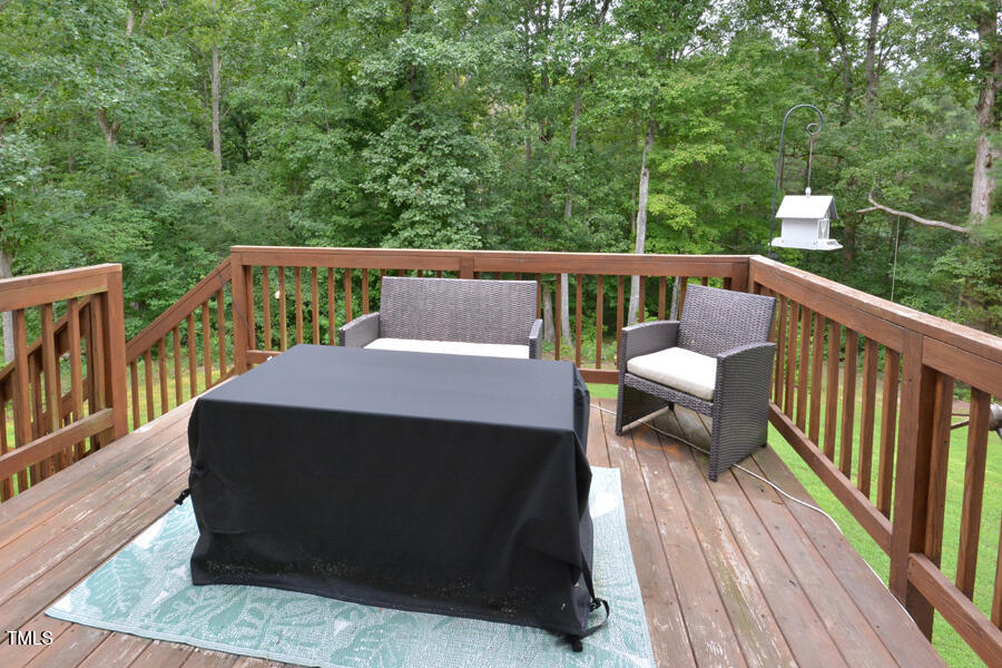 195 Timberwind Road Franklinton, NC 27525 - Photo 15 of 28 a balcony with wooden floor outdoor seating and yard in the back