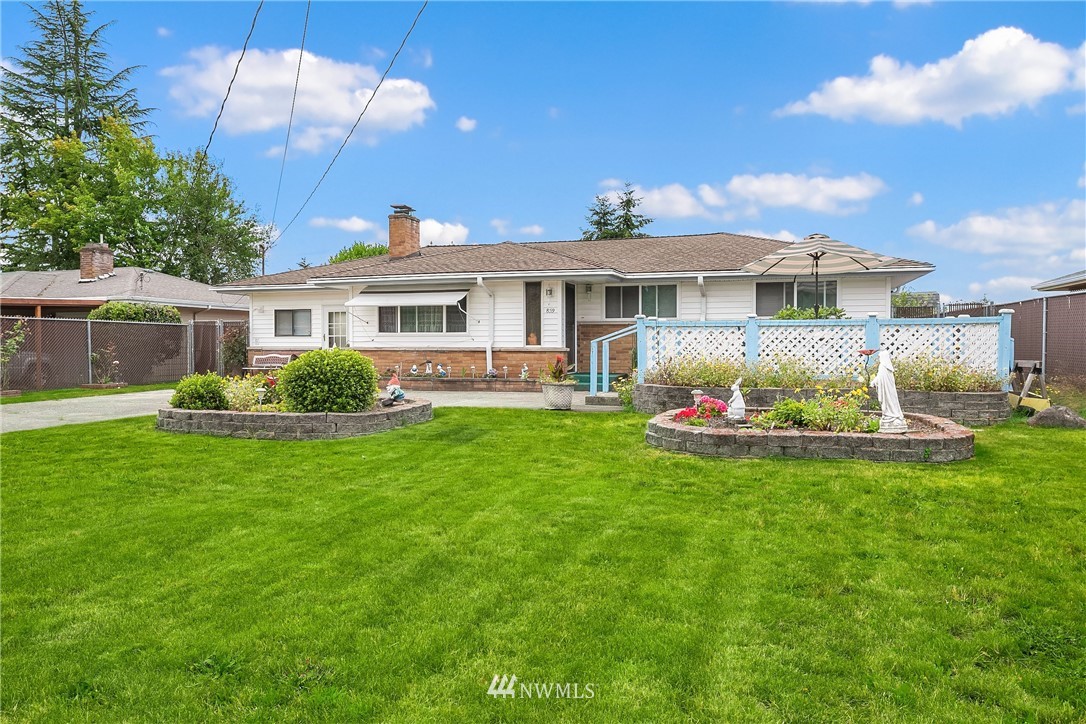 859 Monroe Avenue Northeast Renton, WA 98056 - Photo 1 of 23 a front view of a house with garden