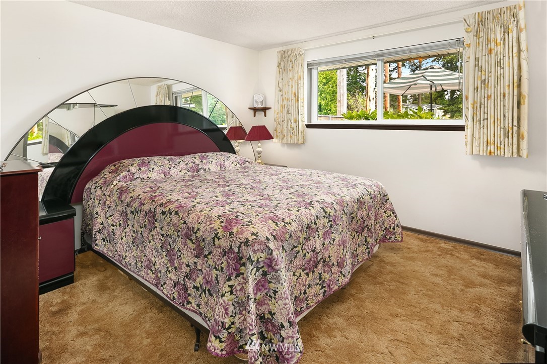 859 Monroe Avenue Northeast Renton, WA 98056 - Photo 14 of 23 a bed sitting in a bedroom next to a window