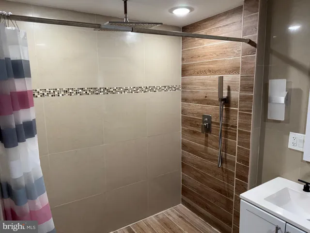 a bathroom with a shower and a sink