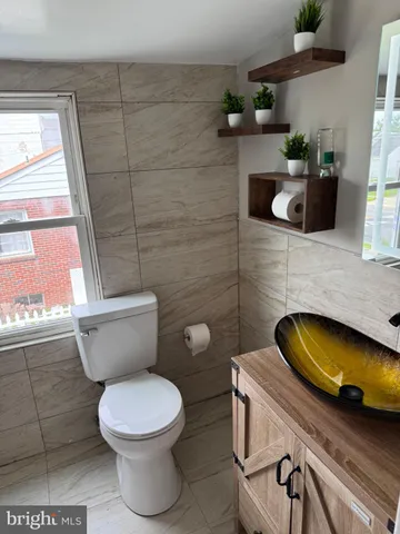 a bathroom with a toilet a sink and window