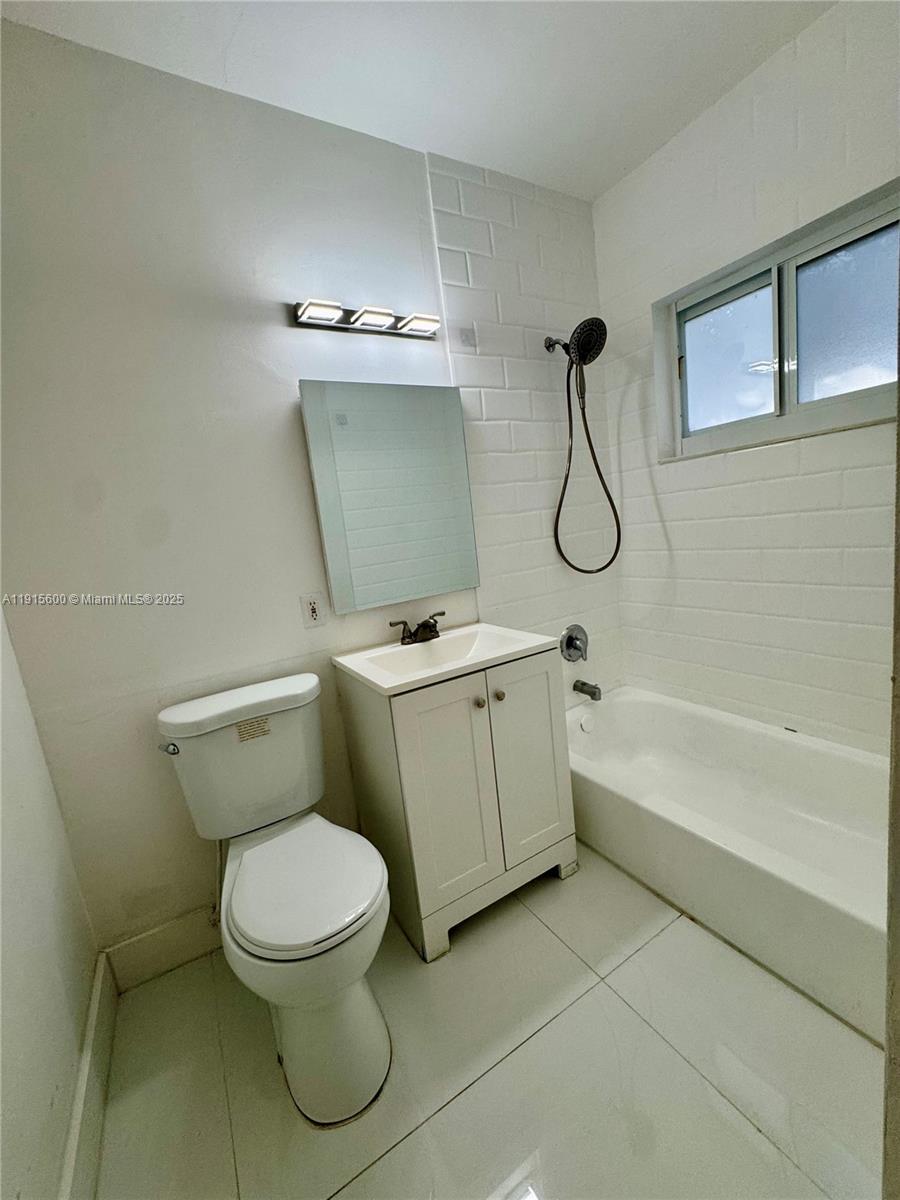 300 Mendoza Avenue, Unit 3 Coral Gables, FL 33134 - Photo 11 of 19 a bathroom with a toilet and a bathtub