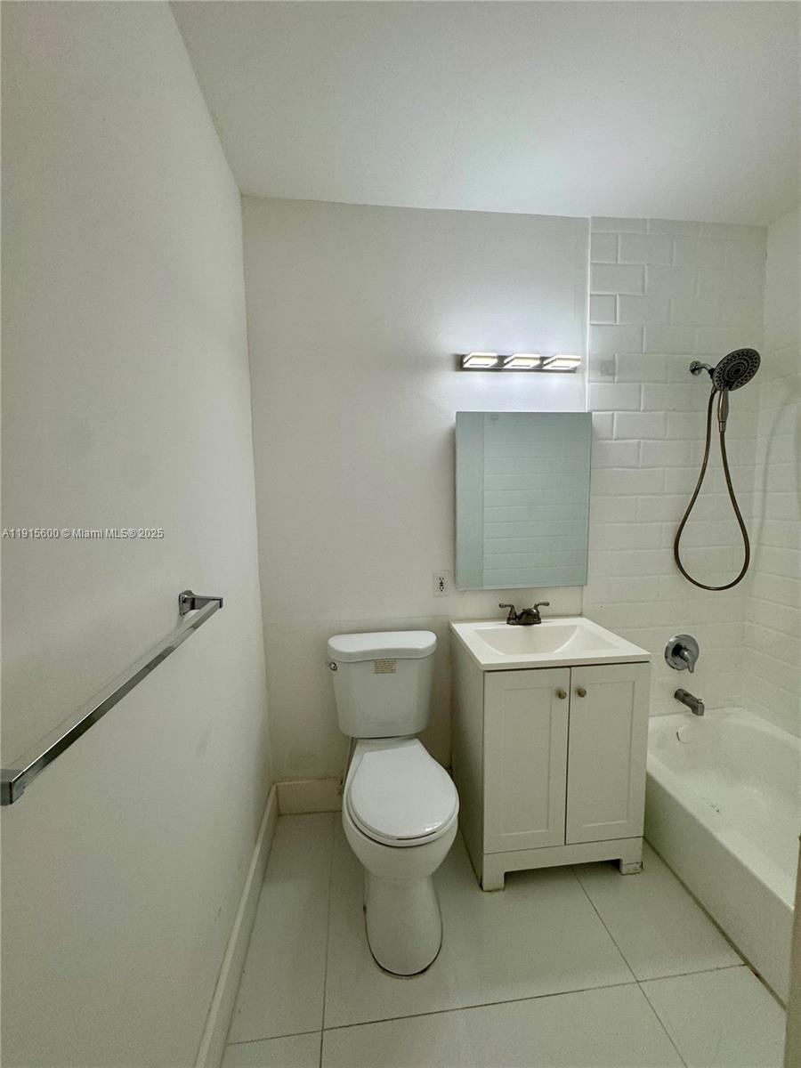 300 Mendoza Avenue, Unit 3 Coral Gables, FL 33134 - Photo 13 of 19 a bathroom with a toilet sink and mirror