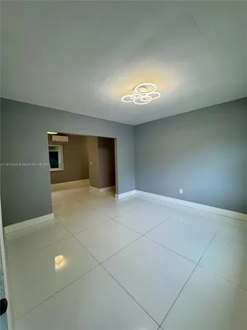 a view of an empty room with a windows