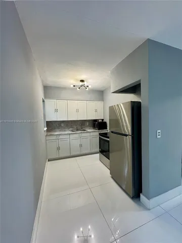 a large kitchen with cabinets and stainless steel appliances
