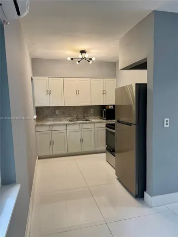 a large kitchen with cabinets and stainless steel appliances