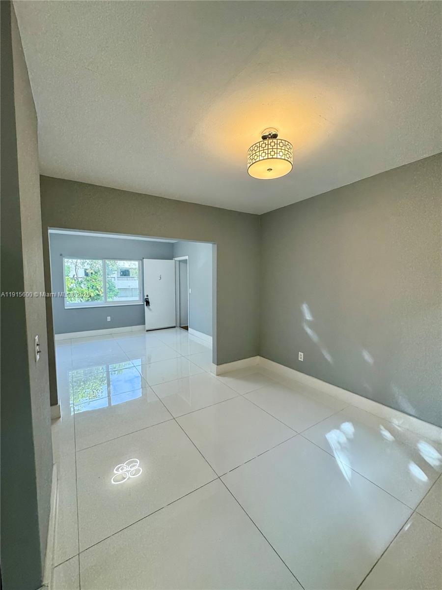 300 Mendoza Avenue, Unit 3 Coral Gables, FL 33134 - Photo 5 of 19 a view of an empty room with a window