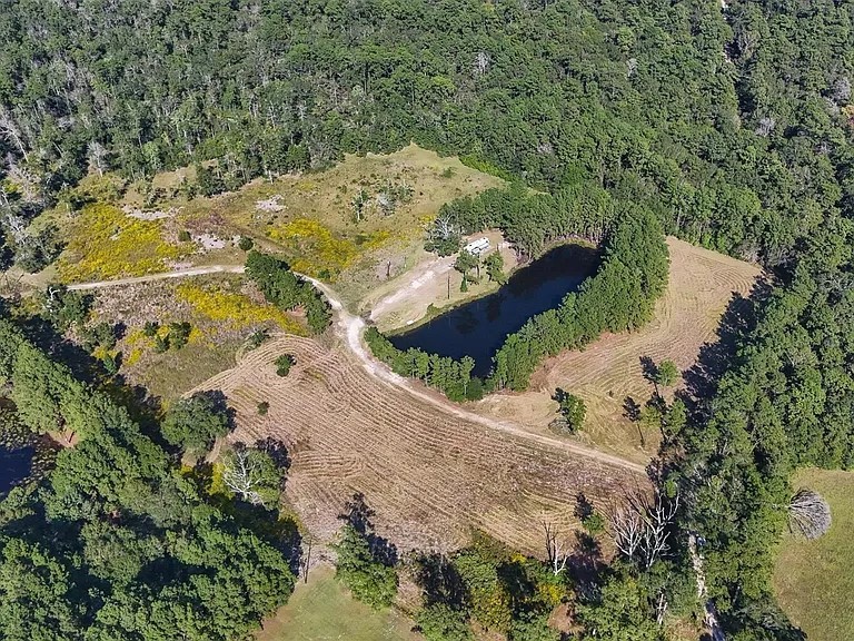 an aerial view of a house with a yard