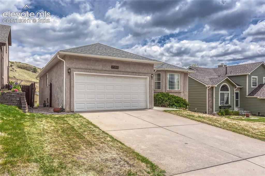 7285 Julynn Road Colorado Springs, CO 80919 - Photo 3 of 45 a front view of a house with a yard