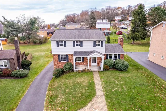 a aerial view of a house next to a big yard