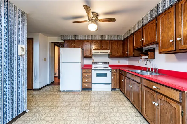 a kitchen with a stove a sink and a microwave