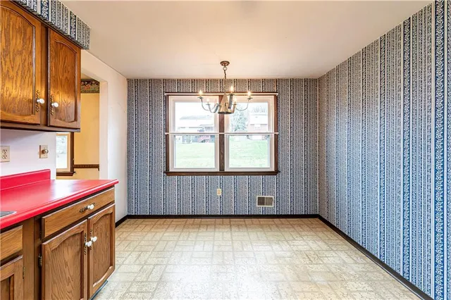 a view of hallway with stairs and wooden floor