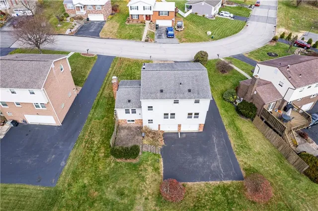 a view of a house with a yard and sitting area