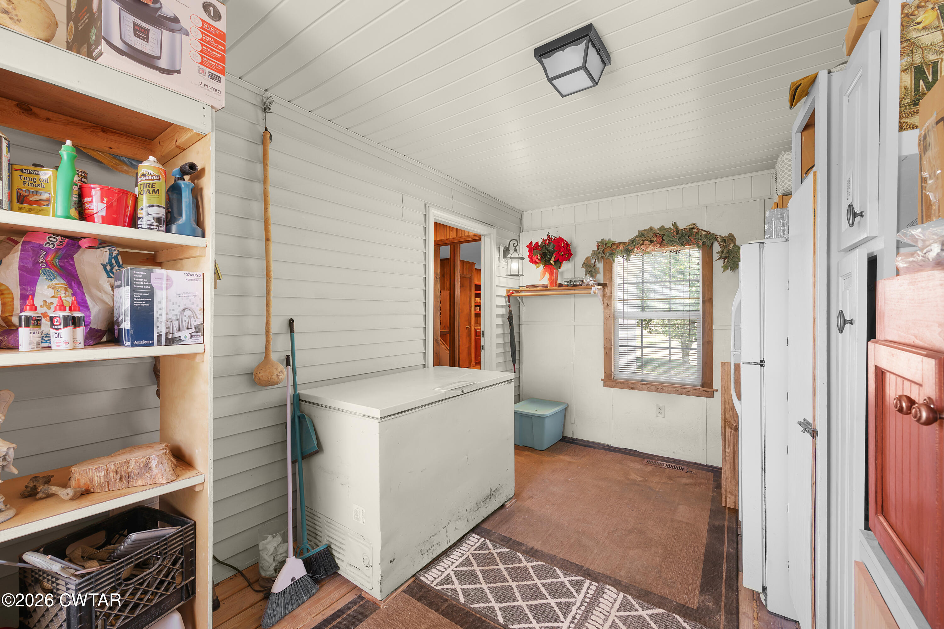 935 Parkers Camp Road Saltillo, TN 38370 - Photo 18 of 29 a hallway with a stove a dining table and chairs