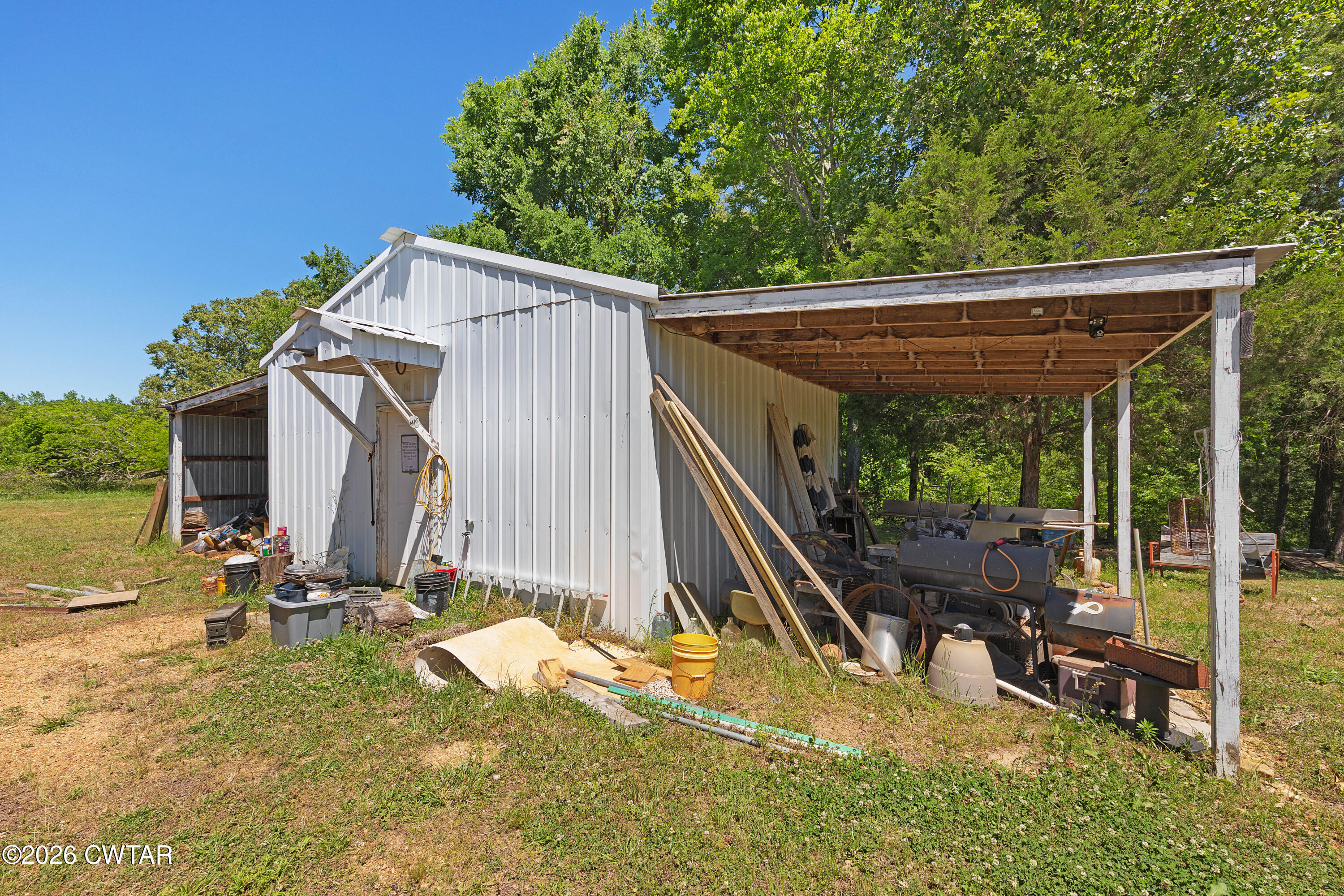 935 Parkers Camp Road Saltillo, TN 38370 - Photo 19 of 29 a view of backyard with a flat tv screen and furniture