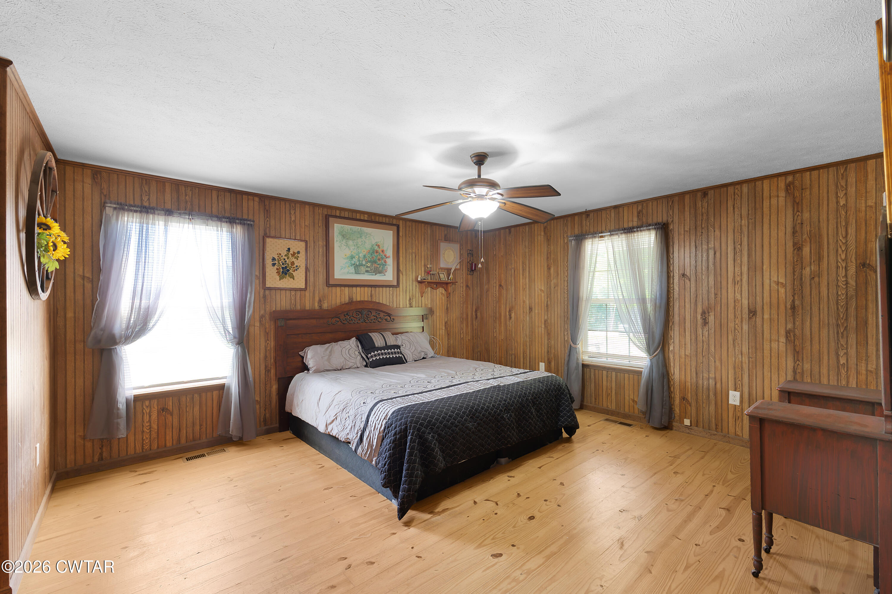 935 Parkers Camp Road Saltillo, TN 38370 - Photo 10 of 29 a bedroom with a large bed and a chandelier
