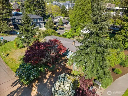 an aerial view of a house with a yard and lake view