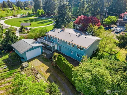 an aerial view of a house with a garden and swimming pool