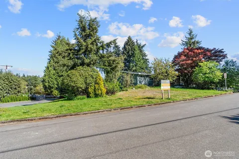 a view of a road with a house in the background