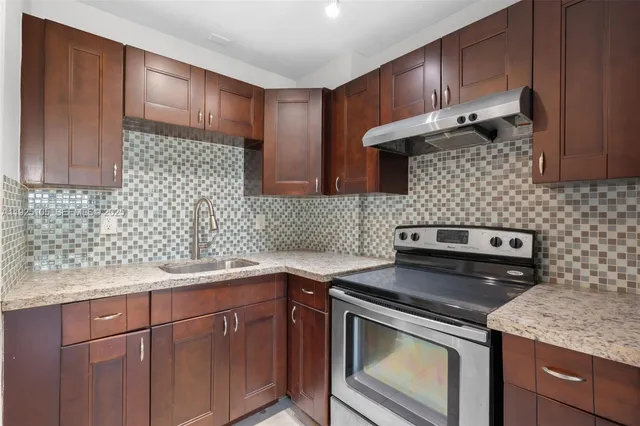 a kitchen with a sink stove and cabinets